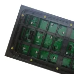 Close-up view of a circuit board featuring green electronic components and connectors.