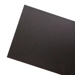 A textured black sheet material with a grid pattern visible on its surface.