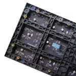 Black circuit board featuring multiple electronic components and connectors arranged in a grid pattern.