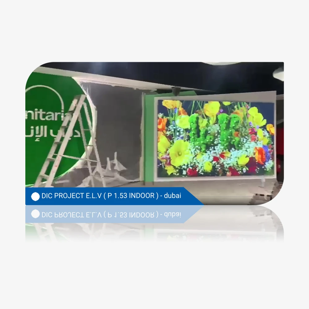 Digital screen displaying a vibrant floral arrangement at an indoor exhibition in Dubai.