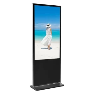 Digital display stand featuring a woman in a white dress walking on a beach.
