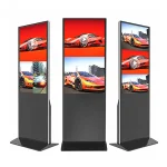 Three digital display kiosks showcasing images of a red sports car in an urban setting.