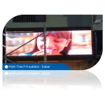 Digital display screen showing a young girl smiling while eating in Dubai.