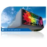 Large outdoor digital display in Dubai featuring colorful graphics for a 10th anniversary event.