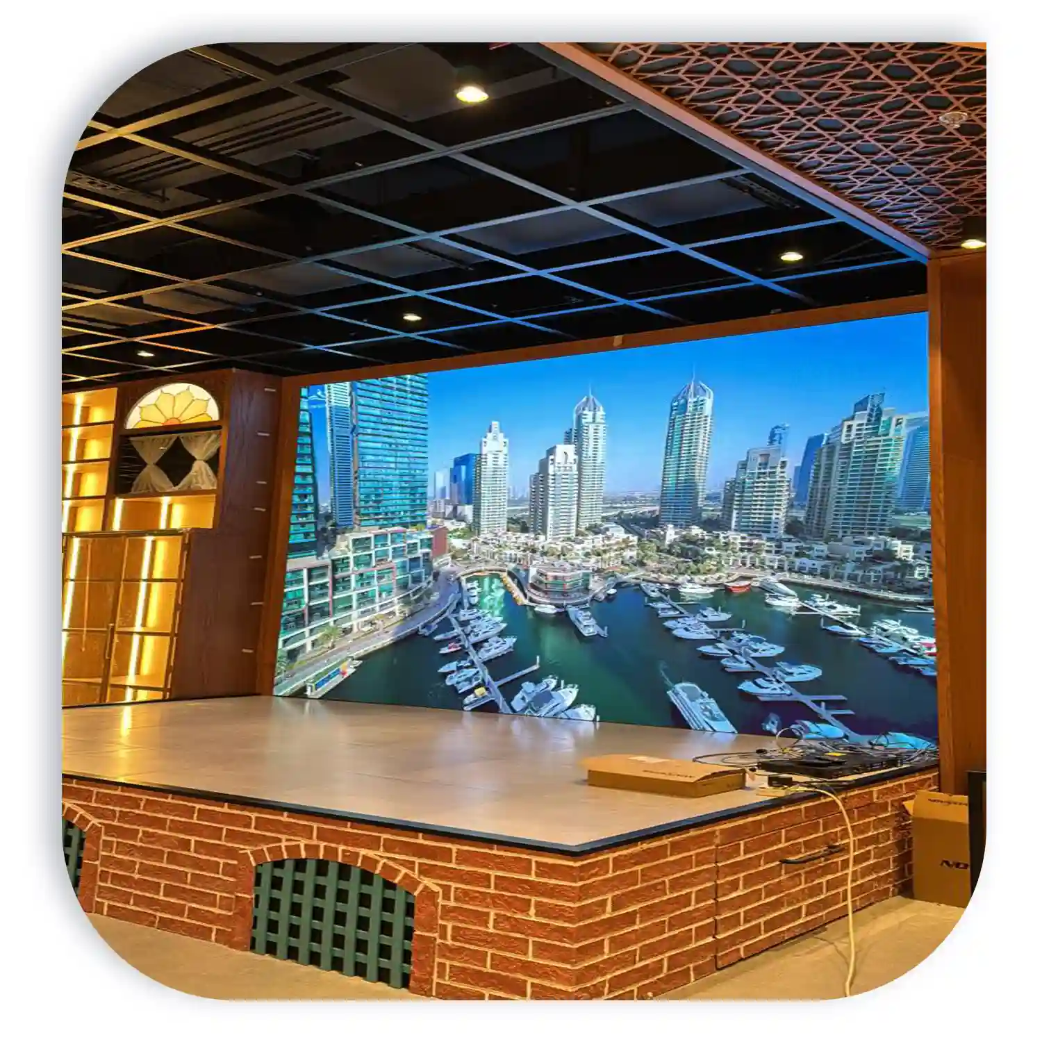Large digital display of Dubai Marina showcasing skyscrapers and yachts in the harbor.
