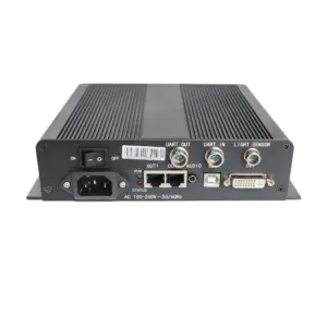 Black electronic device featuring various ports including UART, audio, and DVI connections on the back panel.