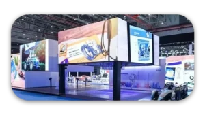 Exhibition booth featuring large digital displays and product presentations at a trade show.