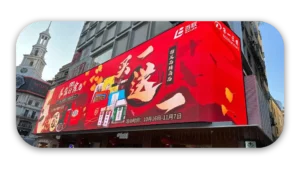 A large digital billboard featuring various product images and promotional text in a vibrant design.
