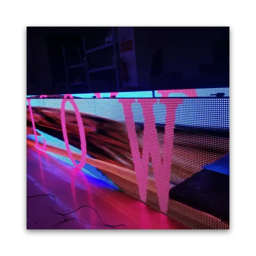 LED display panel with vibrant colors and abstract patterns in a dark setting.