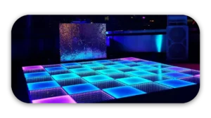 Dance floor featuring illuminated LED panels in blue, pink, and purple colors.